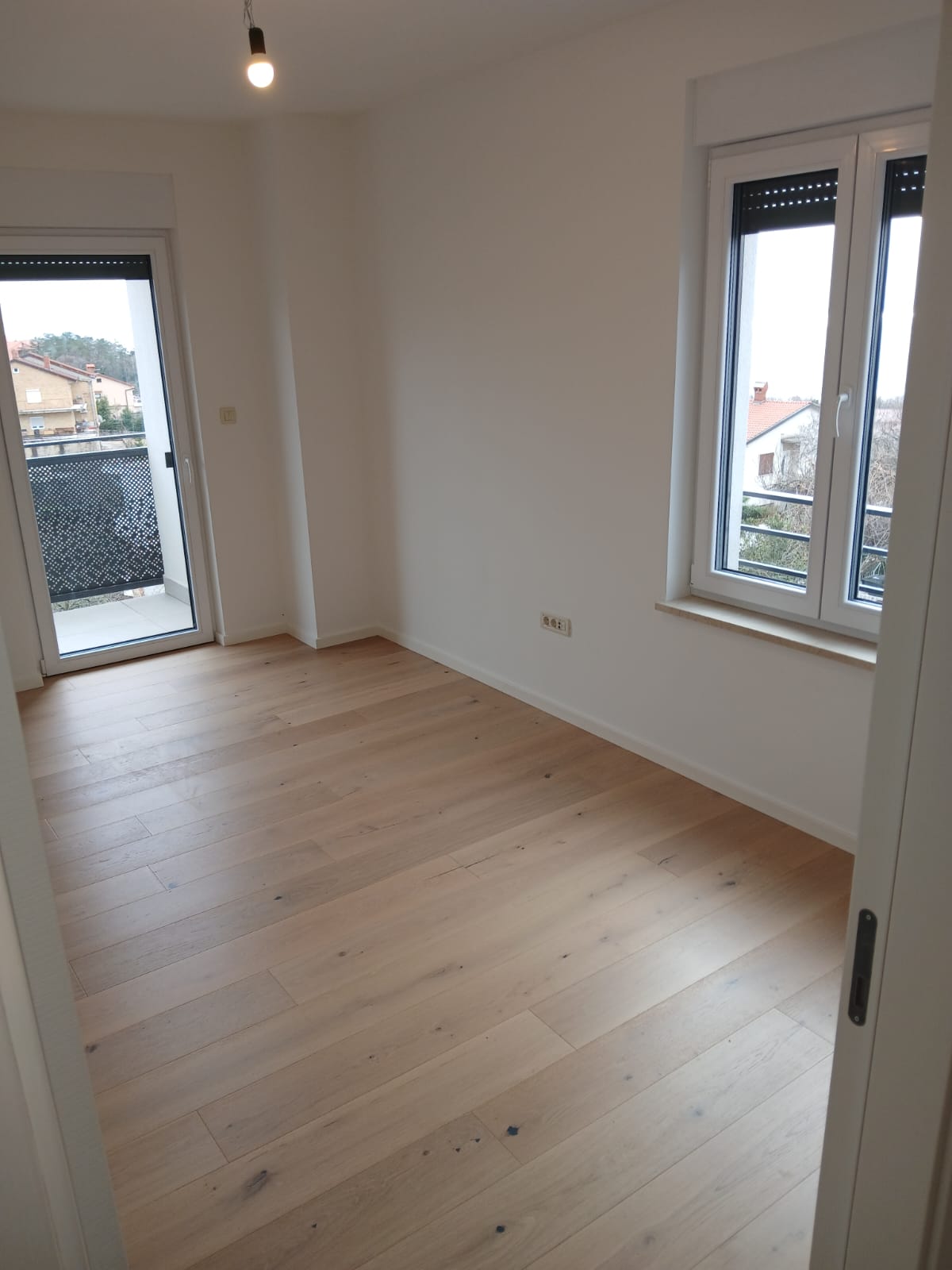 Finished bedroom with hardwood flooring