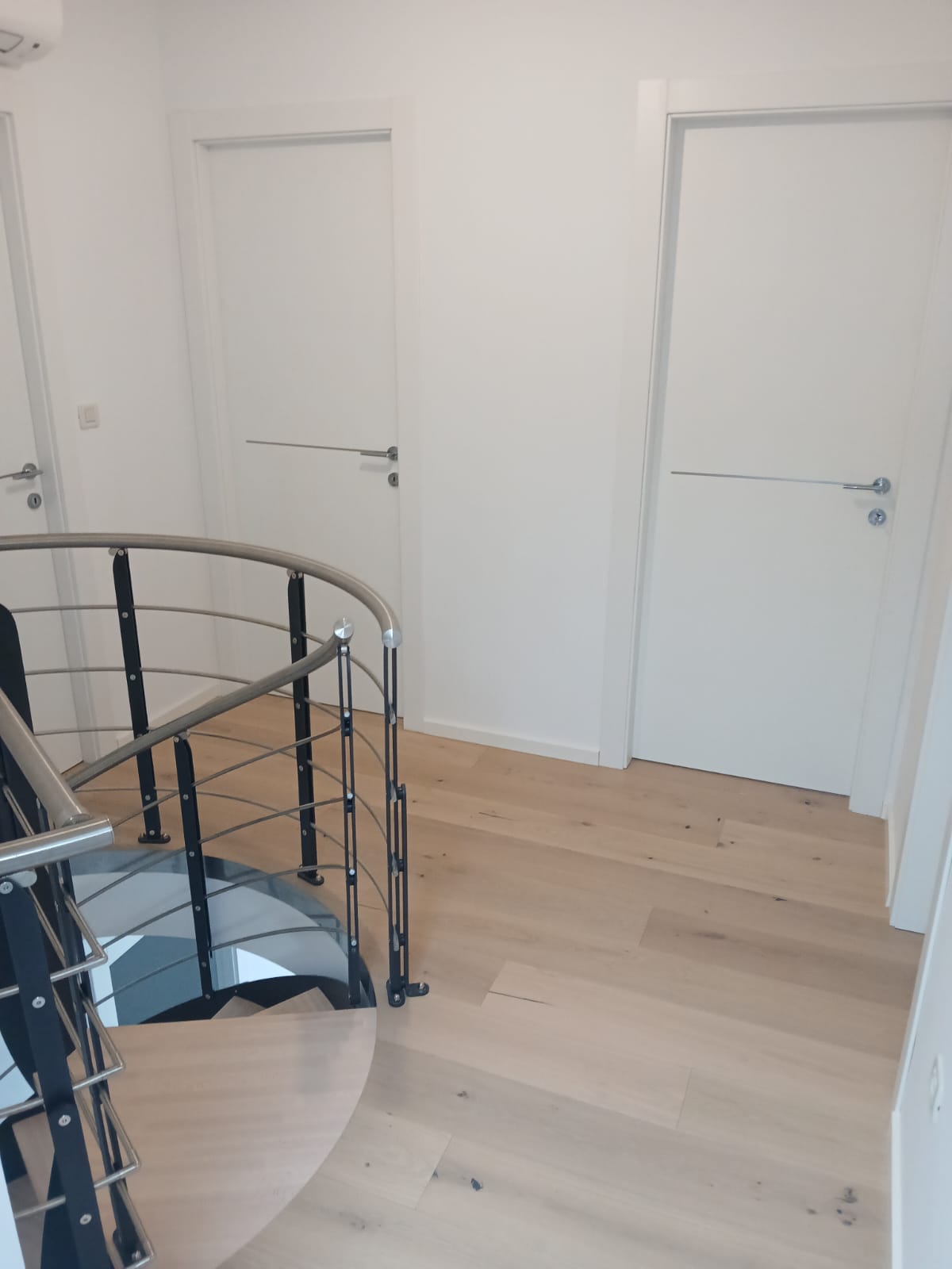 Finished hallway with spiral staircase