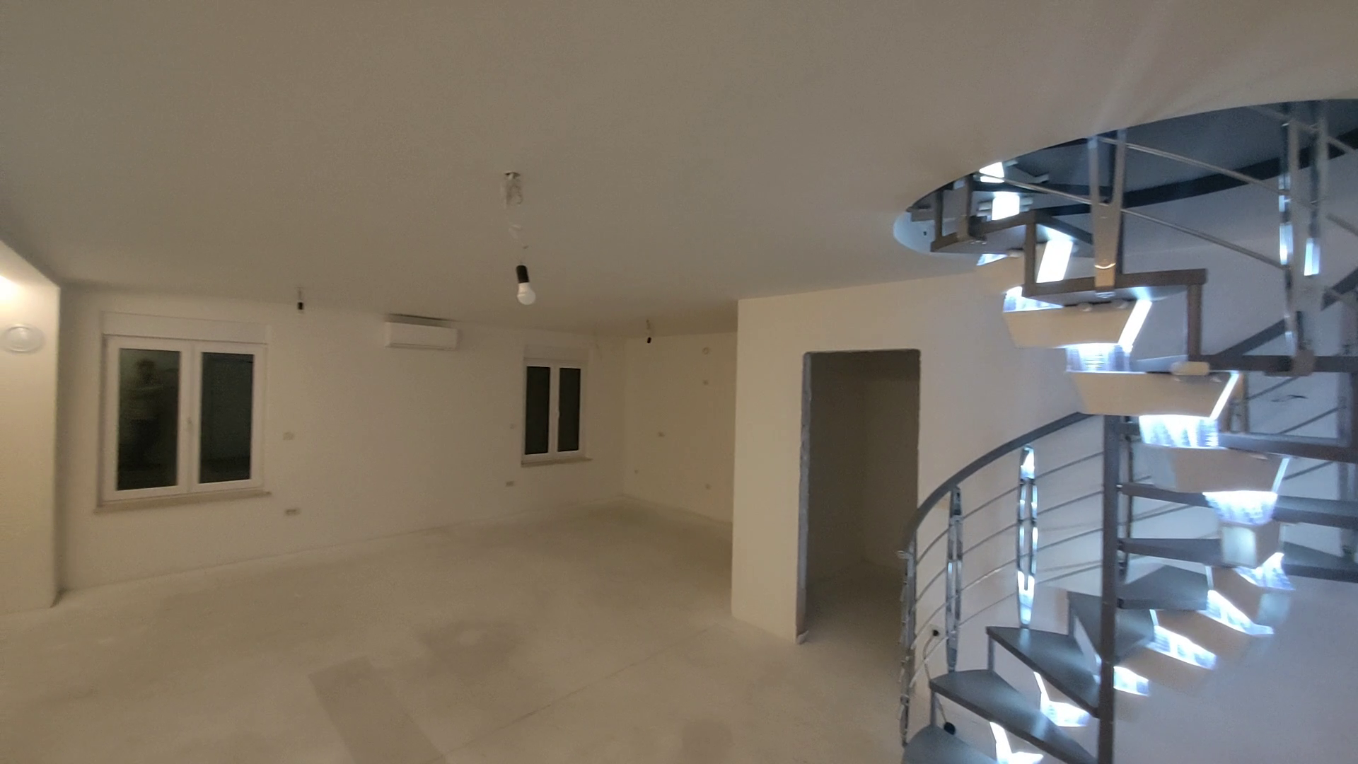 Living room with illuminated staircase